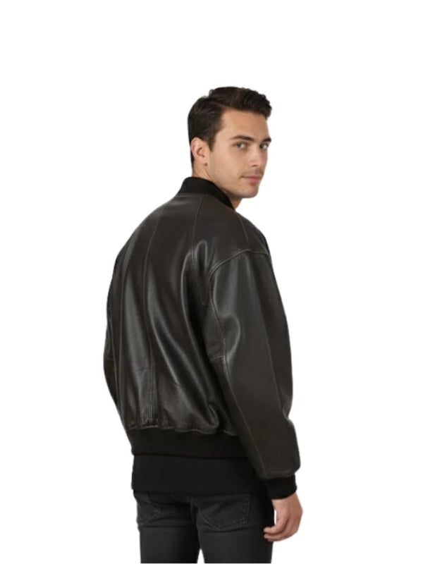 Man wearing a black leather bomber jacket on a white background