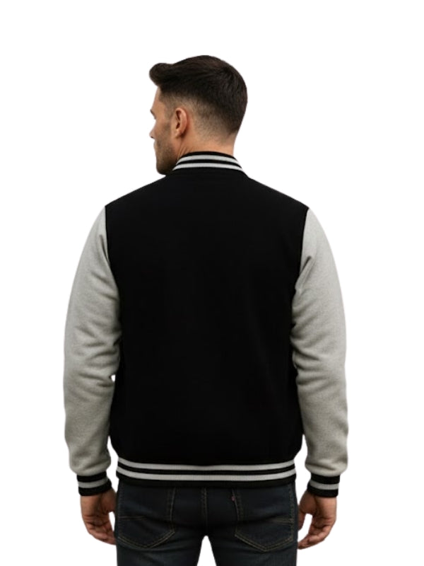 Man wearing a black and gray varsity jacket on a white background